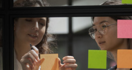 women writing on sticky notes
