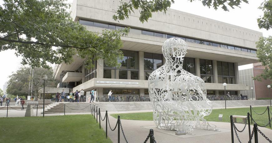 Sculpture called the Alchemist, which appears with numbers and math symbols shaped into a person, located outside the MIT Student Center 